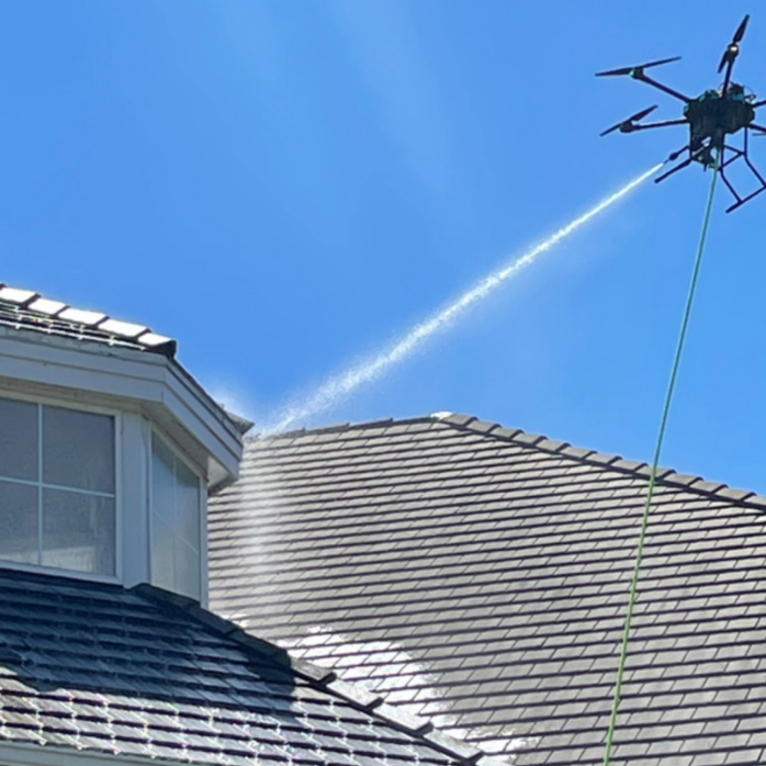 Soft wash roof cleaning on a large canopy-shaded Pinecrest estate roof